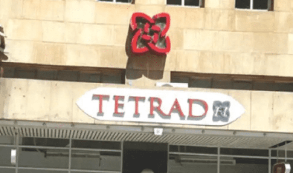 Storefront sign reading 'TETRAD' with a decorative logo above it.