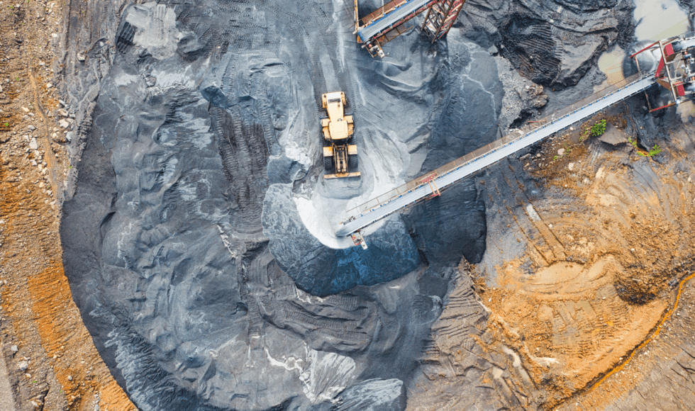 Aerial view of a mining excavation with heavy machinery.