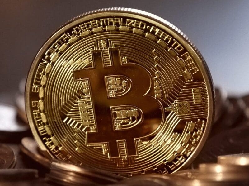 Close-up of a shiny gold Bitcoin coin symbolizing cryptocurrency. Close-up of a shiny gold Bitcoin coin symbolizing cryptocurrency.