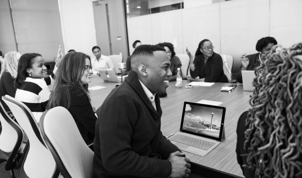 Colleagues enjoying a lively meeting around a conference table.