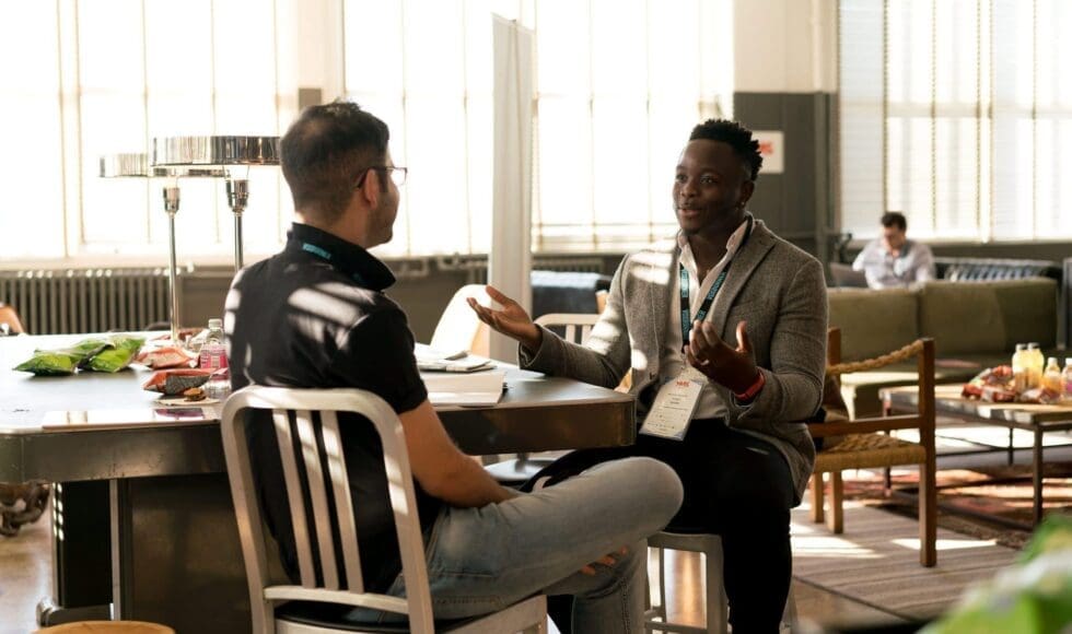 Two men having a friendly conversation in a cozy café.