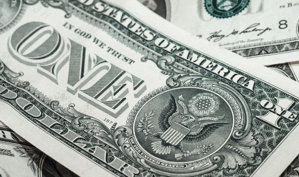 Close-up of a US one-dollar bill showing detailed design.