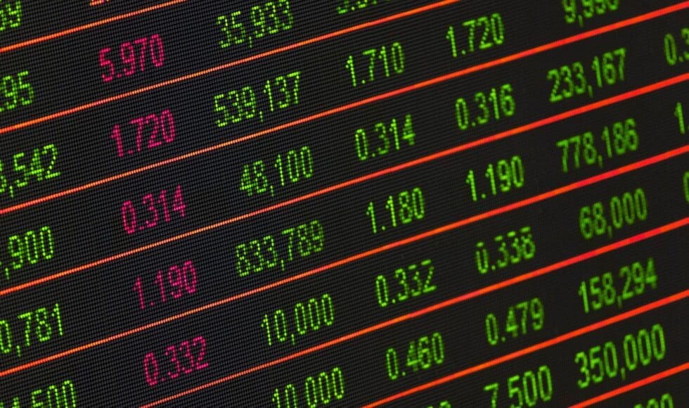 Digital stock market data displayed on a screen with colorful numbers.