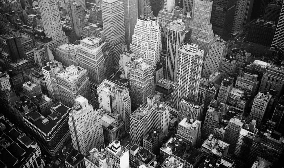 Aerial black-and-white view of dense city skyscrapers.