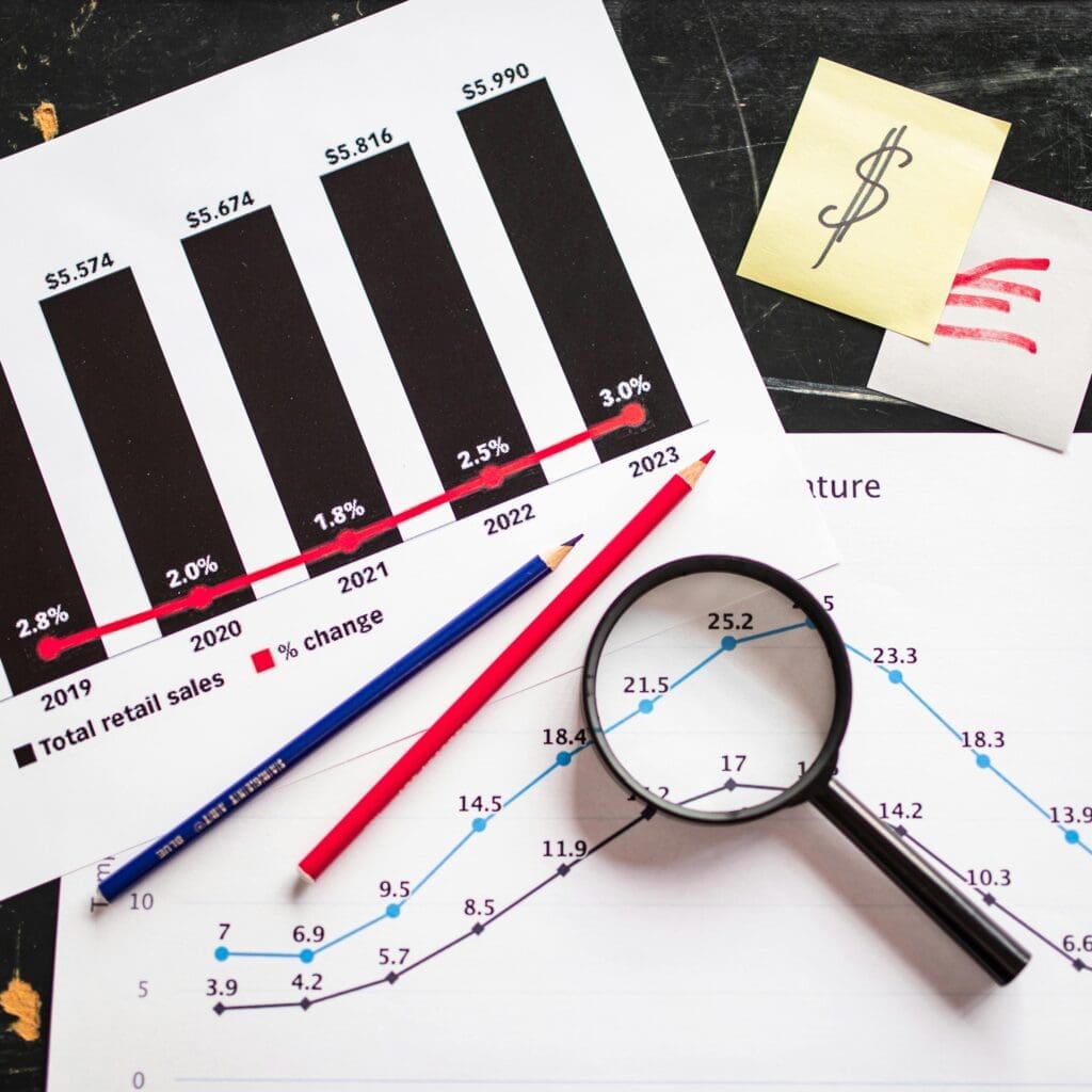 Magnifying glass, pencils, and charts showing data analysis.