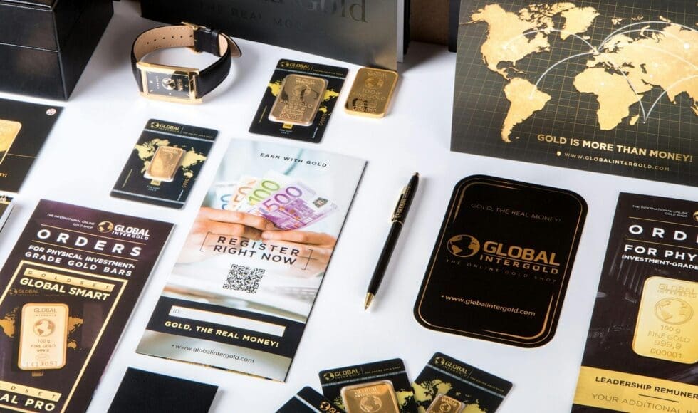 Elegant branded stationery and packaging with a gold and black theme.