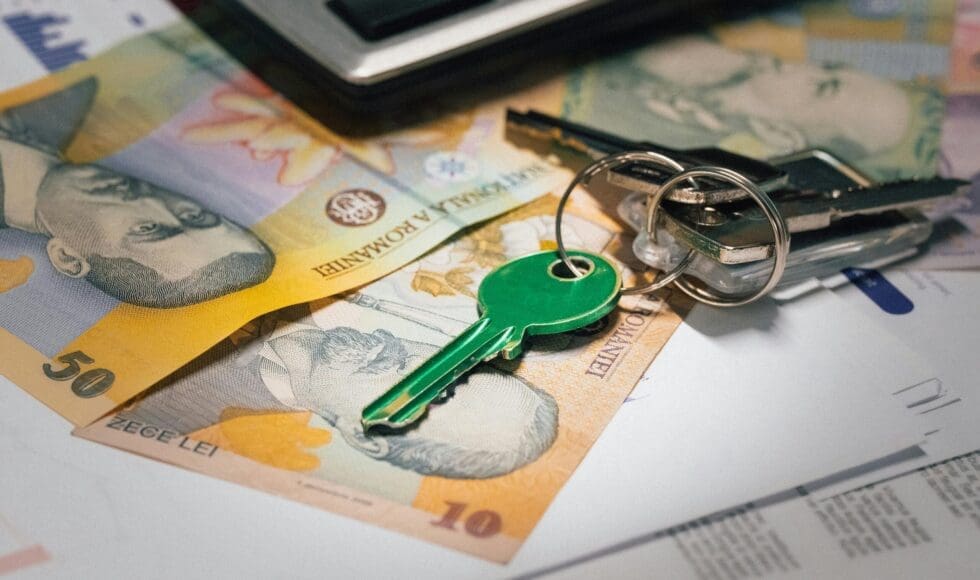 Keys resting on Australian banknotes and a document.